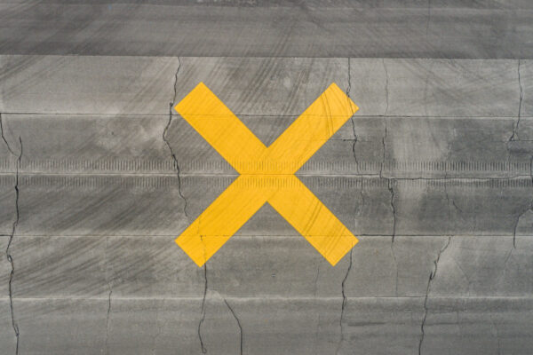 Yellow X on Wood Floor